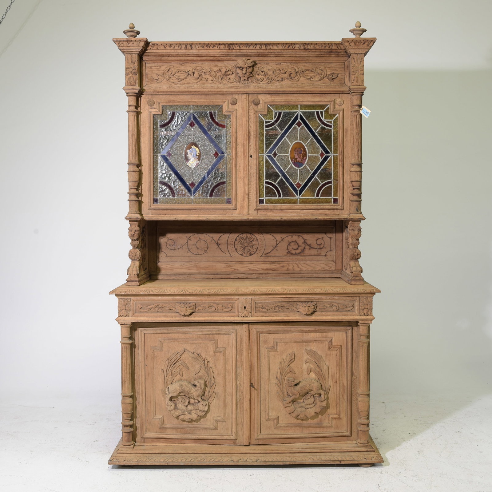 Renaissance Revival Bleached Oak Buffet Deux Corps: French Renaissance Revival Bleached Oak Buffet Deux Corps / Double Buffet featuring stained leaded glass upper doors supported by winged griffin figural carvings - 88.5 in tall x 55 x 22