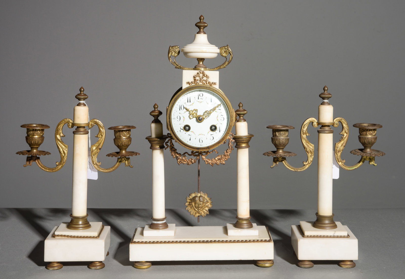 3pc French White Marble & Gilded Metal Mantle Clock: 3pc French White Marble & Gilded Metal Mantle Clock - Clock is 15 in tall x 8.5 x 4.25, the garnitures are 10.5 in tall x 7 x 3.5 each