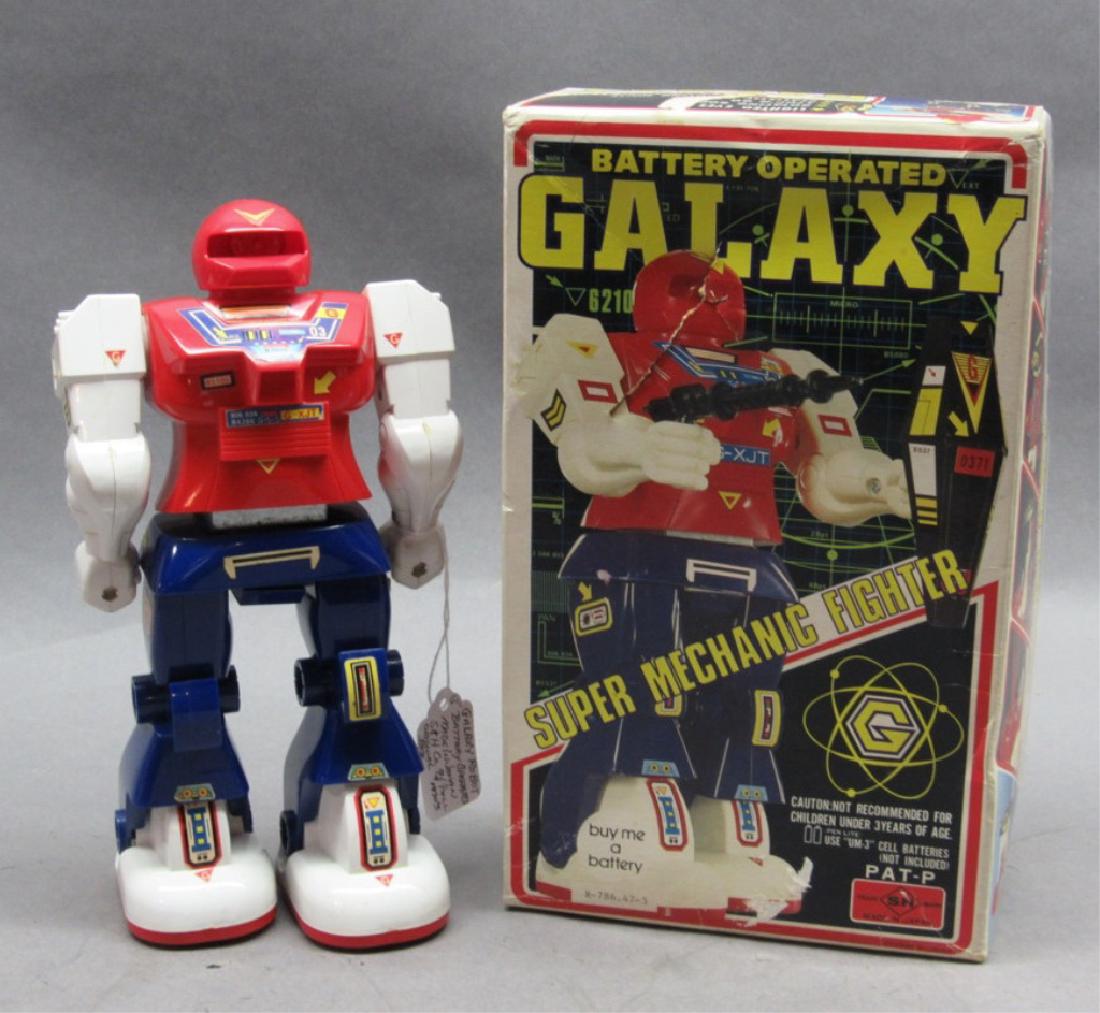 Galaxy Robot- Battery Operated- Original box: 9 1/4" tall. Plastic robot with paper decals, some decals show a little wear, box shows storage wear, missing gun, has loose wire but runs.