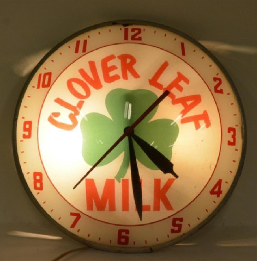 Clover Leaf Milk Lighted Advertising Clock: Very nice Clover Leaf Milk Lighted Advertising Clock. The clock runs and lights great and features a glass face and crystal. The clock was made by Advertising Products, Inc. Measures 15" in diameter.
