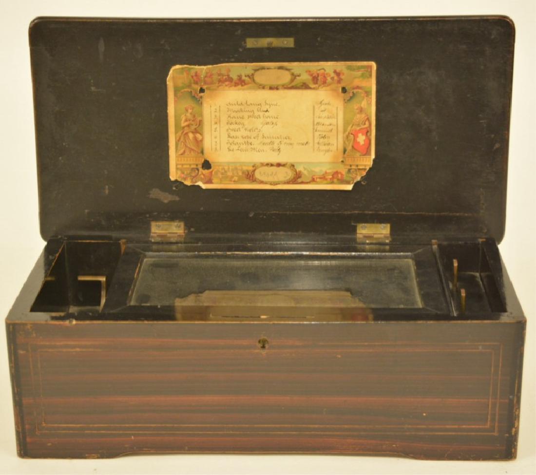 Antique Swiss Music Box-8 Airs: Box is in very good physical condition with an inlaid lid. It works on & off and will need a cleaning and adjustments by the new owner, the crank is not latching. Includes the song list on the inside