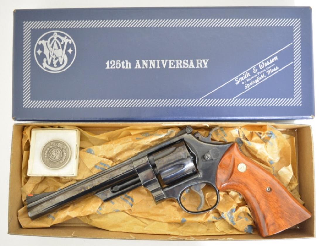 Smith and Wesson 125th Anniversary .45 Cal Revolver MIB: Gun is unfired in the original box with original paperwork. The six-shot revolver has a 6.5" barrel, blue finish, comes with a commemorative medal and is a Model 25-3 1955 .45 Target Revolver. SN: 240