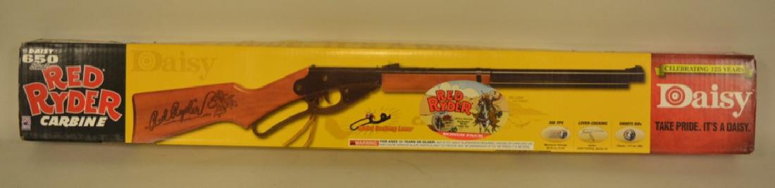 Daisy 125 Years Red Ryder BB Carbine MIB: New in the original unopened box, lever action, 650 shot, has wood stock, comes with special edition Red Ryder BB tin. Model 1938B.