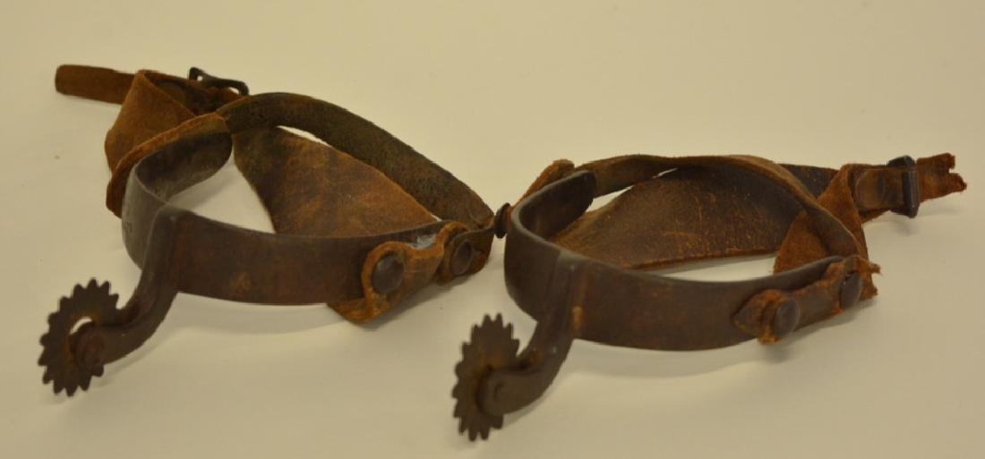 Pair Of Vintage August Buermann OK Cowboy Spurs: Nice pair of marked Buermann's OK iron cowboy spurs with leather belts. The leather is weak and tore on one spur.