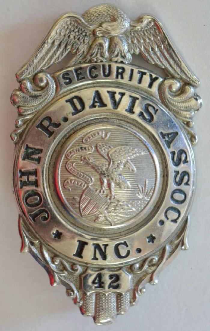 Obsolete John R. Davis Assoc. Security Badge: Nice obsolete John R. Davis Association Security badge. Badge is in nice condition. Badge measures approximately 2 1/4" tall by 1 3/4" wide.