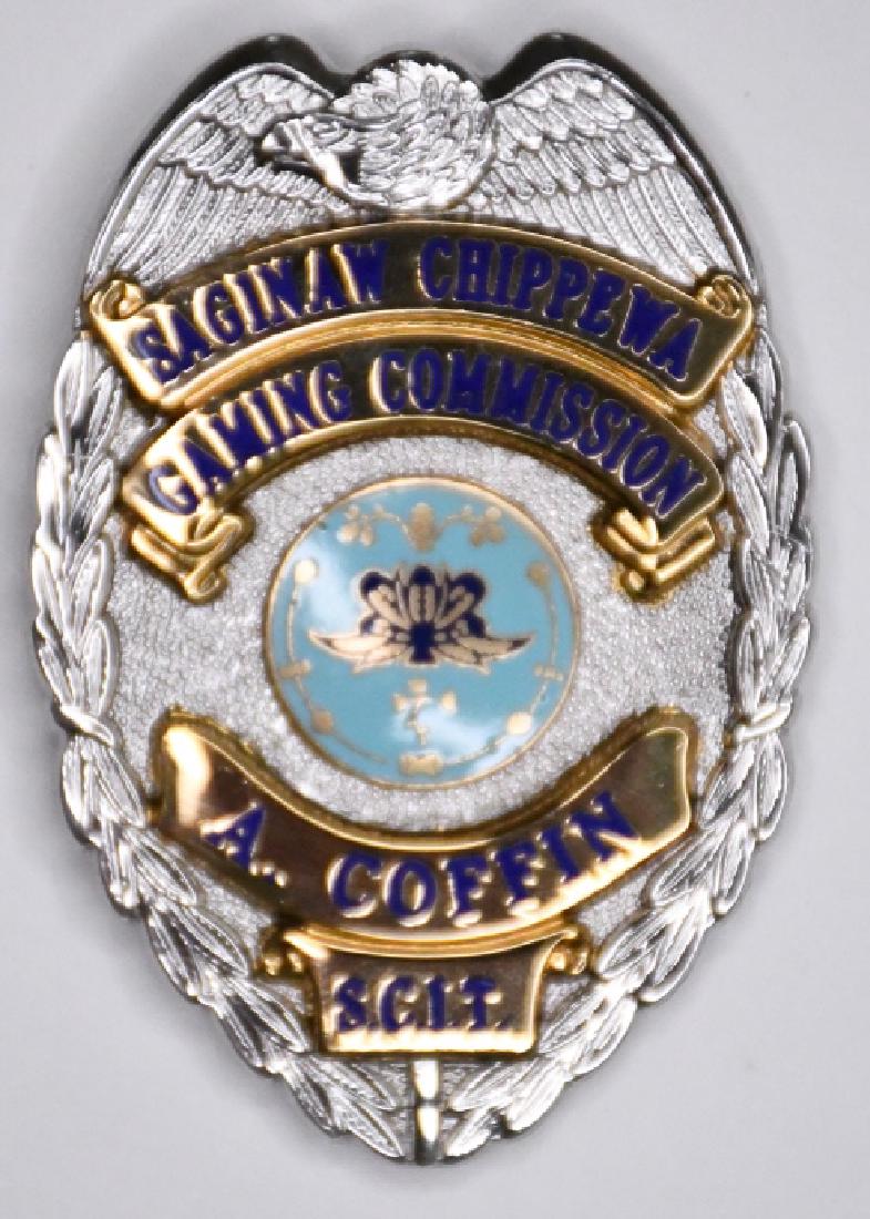 Obsolete Saginaw Chippewa Gaming Comm. Badge: Nice obsolete Saginaw Chippewa Gaming Commission Badge owned by A. Coffin. Badge is in nice condition with a clip back. Badge measures approximately 2-1/2" tall by 1-3/4" wide. Made by Blackinton.