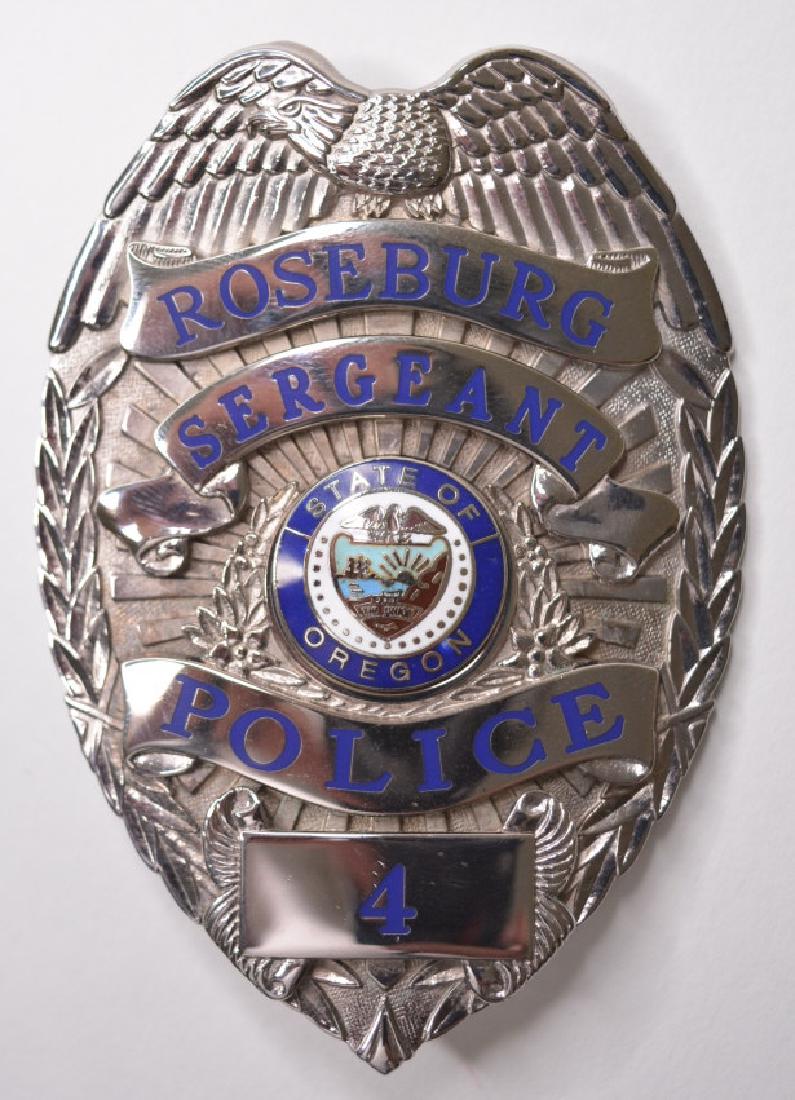 Obsolete Roseburg Oregon Police Sergeant Badge #4: Nice obsolete Roseburg Oregon Police Sergeant Badge #4. The badge is in great condition with the pinback. Measures approx. 3-1/2" tall x 2-3/8" across. Made by Cruzan Badges.