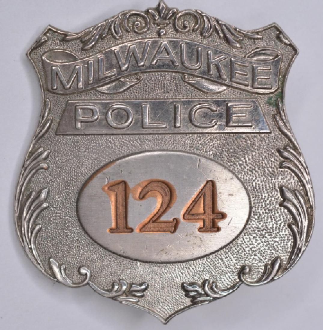 Obsolete Milwaukee Police Badge #124: Nice obsolete Milwaukee Police Badge #124. The badge is in nice condition with the pinback. Measures approx. 2-1/4" tall x 2-1/8" across. Made by Northeast Emblem & Badge.