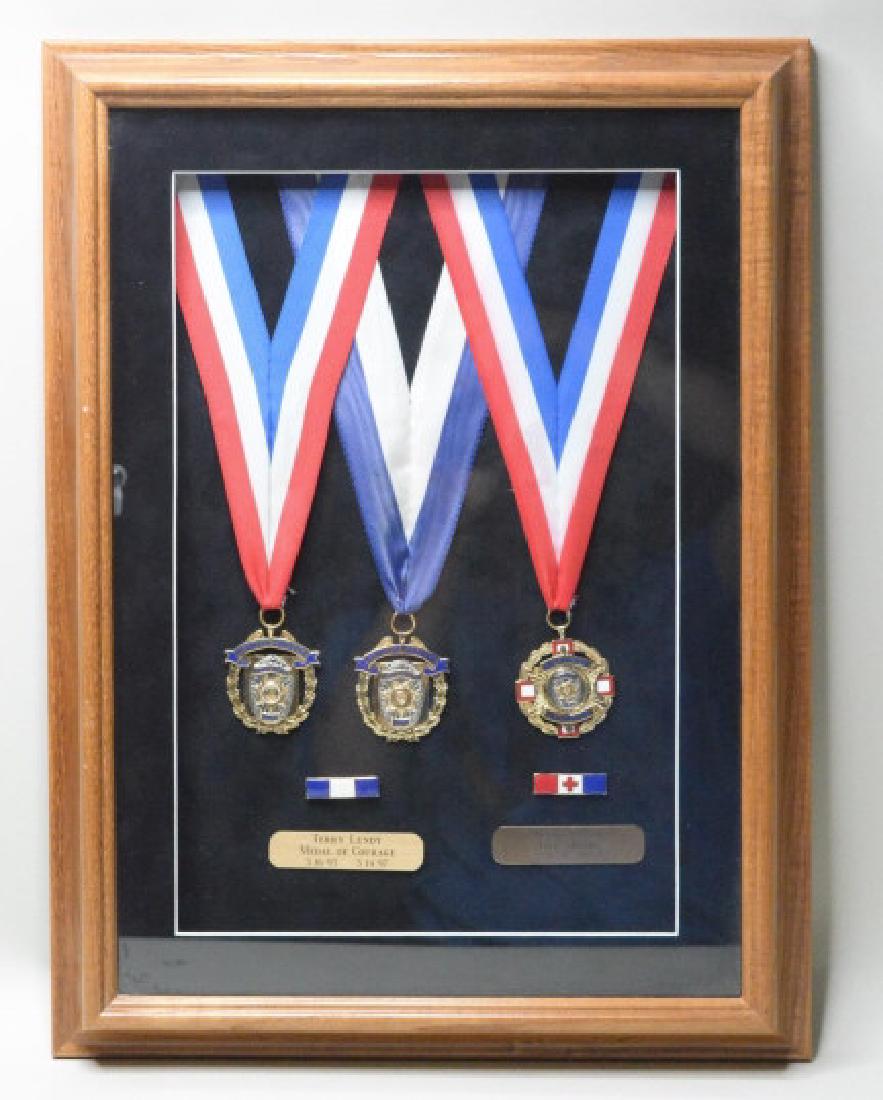 Montebello California Police Medal Lot: This lot includes three Montebello California Police medals. Lot includes a 1993 & 1997 Medal Of Courage, and a 1997 Medal For Life Saving. All thre medals are named and nicely framed. Displays very w