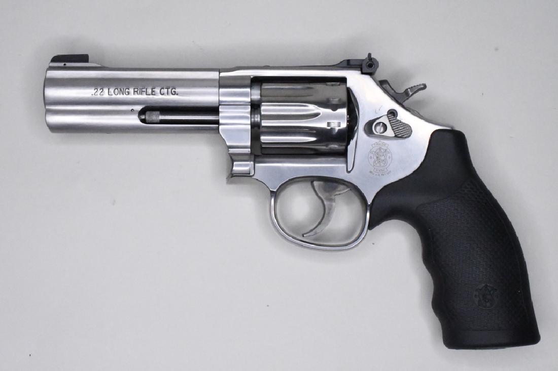 Smith & Wesson Model 617-6 .22LR Revolver In Box: Very nice Smith & Wesson Model 617-6 .22LR Ten-Shot Revolver with 4" barrel. The stainless steel revolver is in near new condition in the original Smith & Wesson hard case with lock & instructions. SN