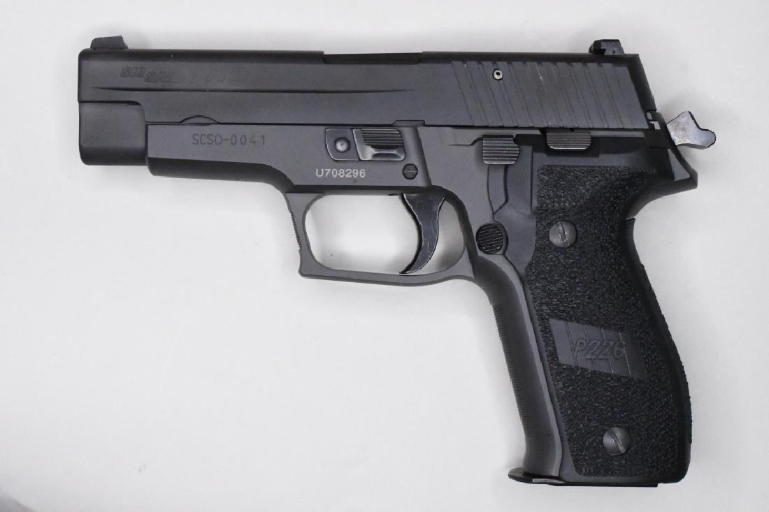 Sig Sauer P226 .40 S&W Pistol In Box: Near new in box Sig Sauer Model P226 semi-automatic pistol in .40 S&W. The blued finish pistol has a 4.4" barrel and is in great near new condition in the original hard case with lock, two magazines, 