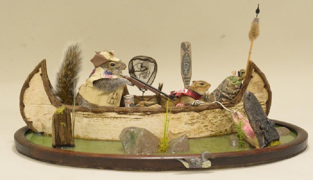 Gray Squirrel And Chipmunk On Canoe Display: Excellent gray squirrel and chipmunk in a canoe, catching an alligator on a realistic water resin base. Extreme attention to detail. Boat is full of supplies. Great tabletop display. Measures approxim