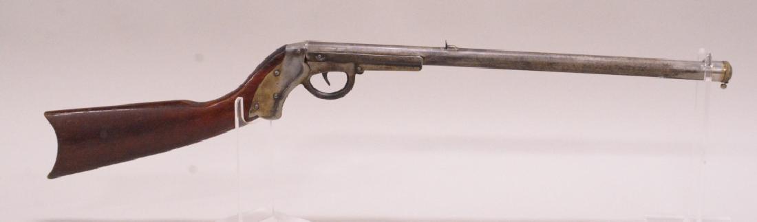 Markham King 1904 Break Barrel Repeating Air Rifle: Vintage Markham-King 1904 break barrel repeating air rifle with spring release repeating mechanism at the muzzle, and oval shaped stock. Nice condition with age appropriate wear.