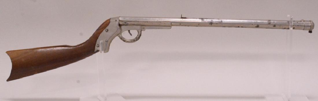 Markham-King 1904 Repeater Break Barrel Air Rifle: Vintage Markham-King 1904 break barrel repeating air rifle with spring release repeating mechanism at the muzzle of the gun, and oval shaped stock. Good working order with replaced rear sight and knob