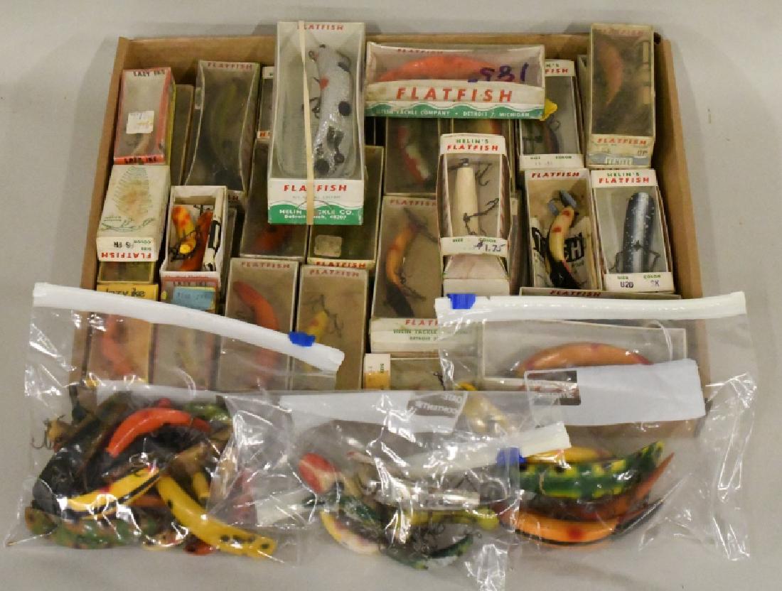 Flatfish Fishing Lure Lot: Nice large lot of vintage flatfish fishing lures. Majority of the lures come in original packaging. Lot includes Helin Flatfish and Lazy Ike. Lures vary in age and condition. Largest lure measures app
