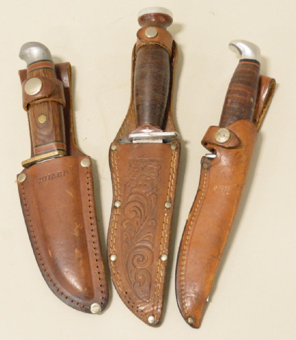 Lot Of 3 Vintage Hunting Knives: Nice lot of three vintage hunting knives with sheaths. Lot includes a Case XX 3 Finn, Sharp Japan,and a Schrade H-15. Knives vary in age and condition. Largest knife mesures approximately 10" overall.