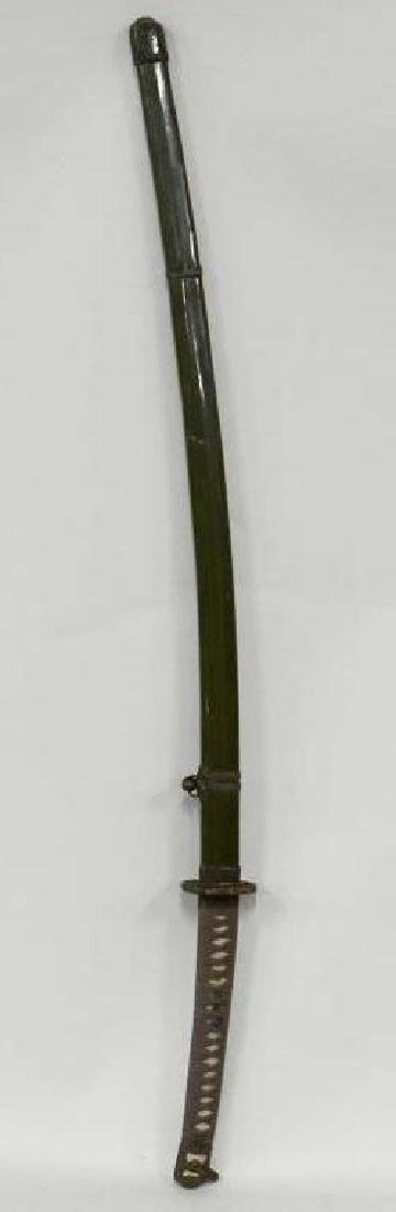 WWII Japanese Samurai Sword With Damascus Blade: Nice WWII Japanese Samurai sword. Nice condition with locking scabbard. Blade is in very nice condition with a few edge chips. Displays extremely well with lotus accents and eel wrapped handle. Marked