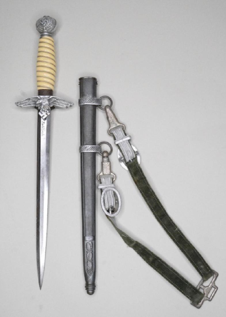 WWII German 2nd Model Luftwaffe Officer Dagger: Nice WWII German Alcoso Solingen 2nd Model Luftwaffe Officers Dress Dagger. The dagger comes with the metal scabbard & fabric hanger with alluminum bullion. Nice condition with some use wear and has t