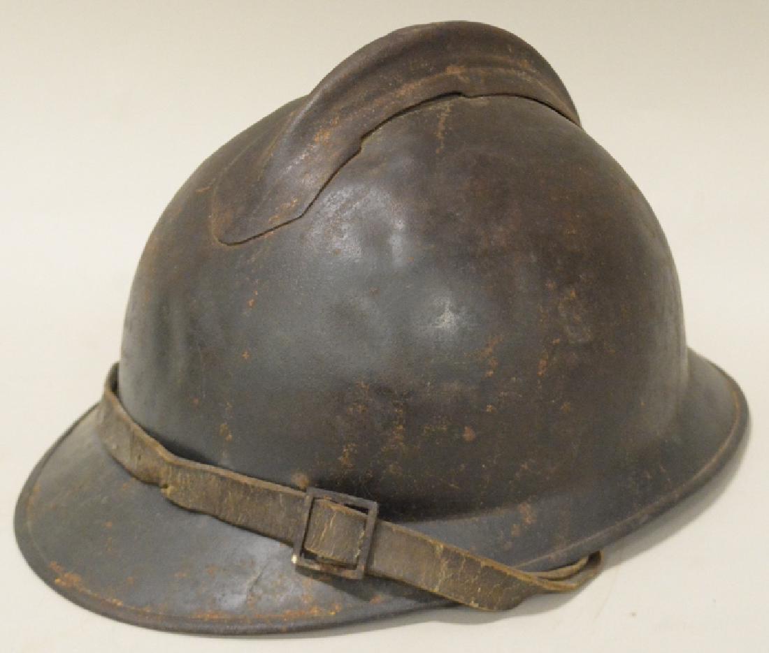 WWI Italian Army Adrian Combat Helmet: Nice WWI Italian Army Adrian 1 piece combat helmet with original liner and chinstrap. Good condition with wear from use and age. Liner and chinstrap are both worn and held on by string. Displays well.