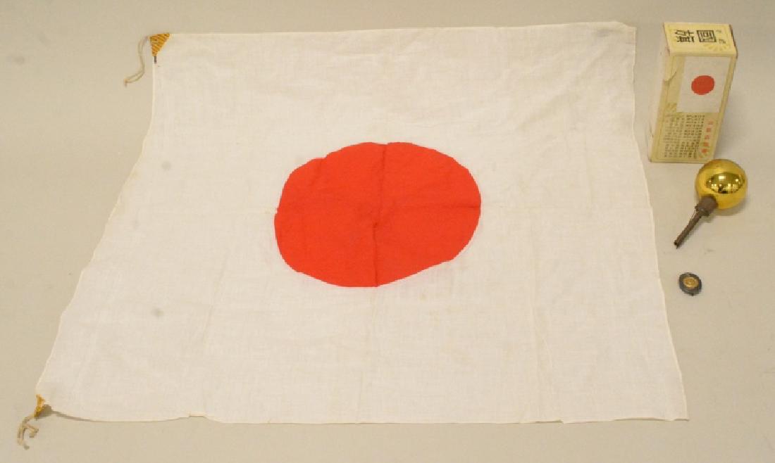 Lot Of WWII Japanese Military Items: Lot includes a Japanese meatball flag with sewn on meatball, a glass flag pole topper, and a japanese military badge. Flag measures approximately 30" across by 26" tall.