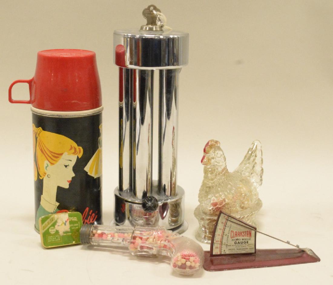 Lot of Candy Jars, Barbie Thermos and more: 1962 Barbie thermos with cup, Lucky coins container with bakelite knob and key- although the key is stuck, glass chicken and pistol candy containers, needle gage in red aluminum.