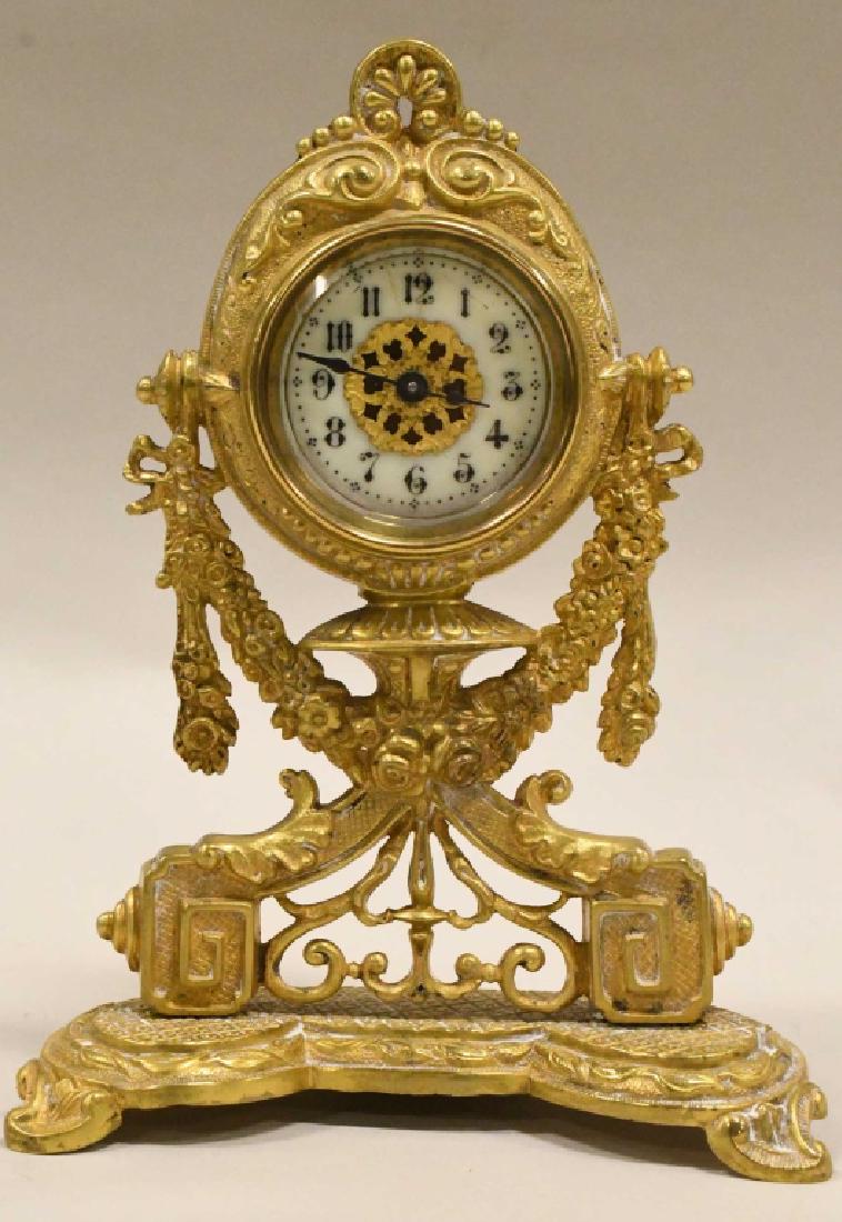 Vintage British United Clock Co. Table Clock: Nice vintage British United Clock Co. wind-up table clock with gold washed metal body . The clock is in nice running condition with some wear. Measures 7.5" tall x 5.75" across x 3" deep.