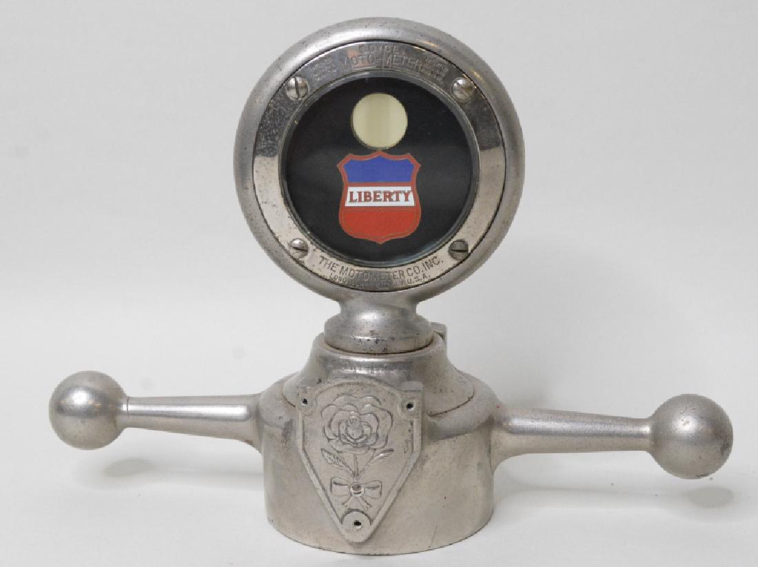 Liberty Boyce Moto-Meter w/ Sterling Auto Cap: Nice Liberty Moto-Meter with Sterling Auto Devices Co. dog bone radiator cap. Nice condition with wear from use and age. Measures approximately 8 1/4" across by 5 3/4" tall.REF#12