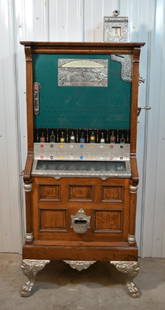 Caille "Bull-Frog" Upright Slot Machine: Very nice Caille "Bull-Frog" 5 cent upright cabinet slot machine . Very nice working condition with oak cabinet, heavily carved ornate designs, nickel plated accents, and claw feet. Cabinet is