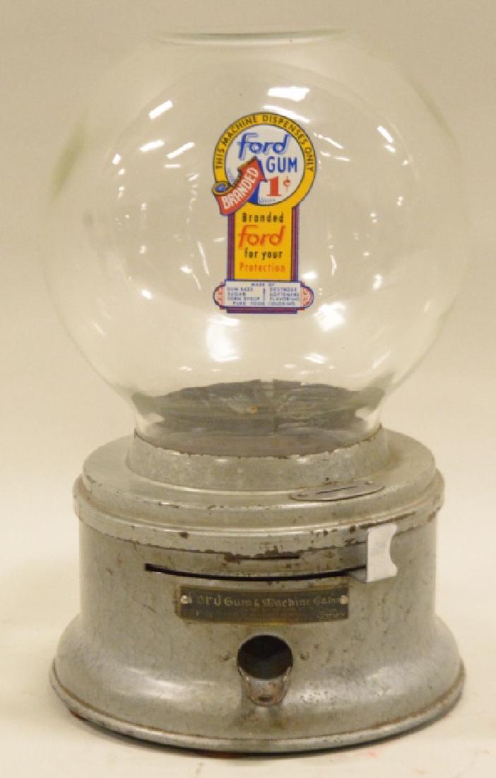 Older Ford Branded Gumball Machine: Bottom unit has some wear and rust on the edges. Glass is in good condition