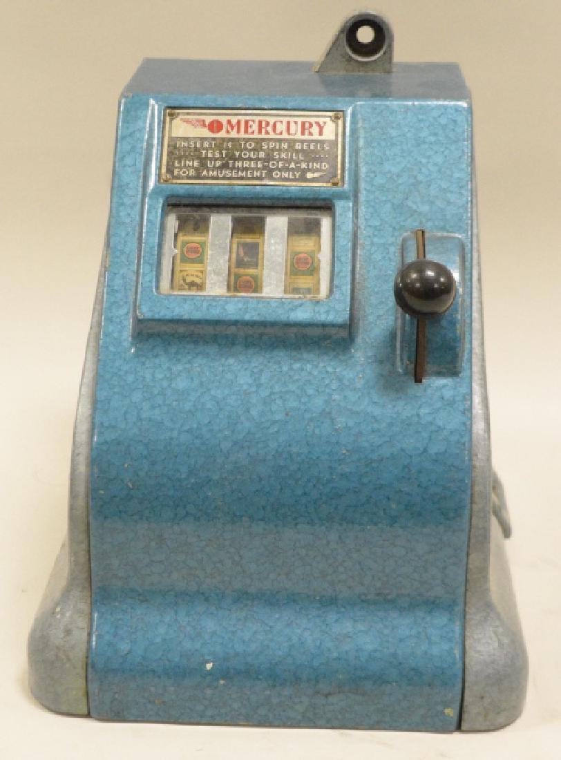 194os Mercury Penny Slot Trade Stimulator: Cast metal in hammered blue and silver finish. Camel, Lucky STrike and other cigarette payout. 10x9x10 inches. No back panel, no key.