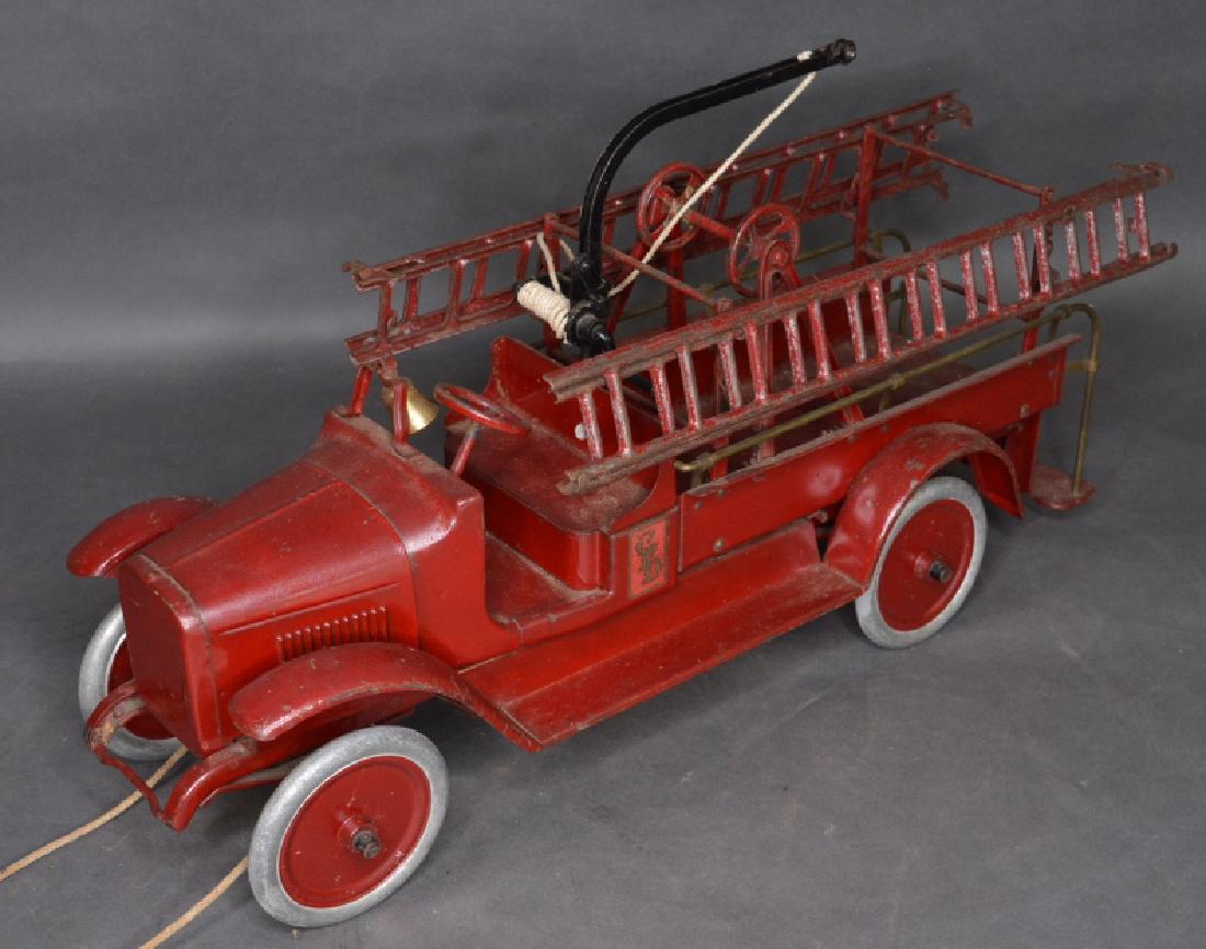 Buddy L Hook and Ladder Truck #205: Pre-1932 pressed steel Buddy L Hook and Ladder Truck. Nice condition with old paint restoration and paint loss. Measures approximately 27" long.