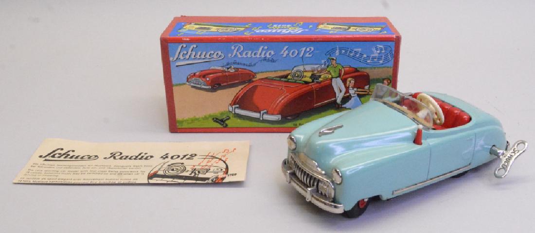 Schuco Wind Up Tin Litho Radio Car 4012: Schuco Radio Car 4012. In original box with instructions and key. In nice condition with light wear. Box in nice condition. Untested.