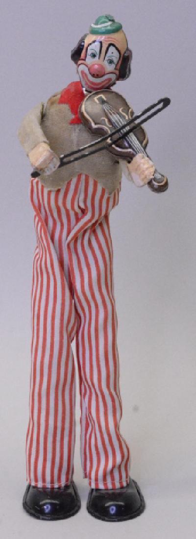 Tin Litho Clown Playing Fiddle Wind Up: Made in Japan wind up . In very nice condition with a few stains on his shirt. Displays very well with great color and graphics. Measures approximately 9" tall.