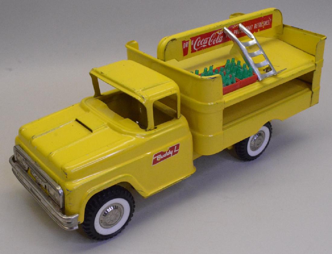 Original Buddy L Coca-Cola Truck: Nice original Buddy L pressed steel Coca-Cola truck. In very nice condition with some decal and paint loss. Comes with three cases and a dolly. Measures approximately 14.5" long.