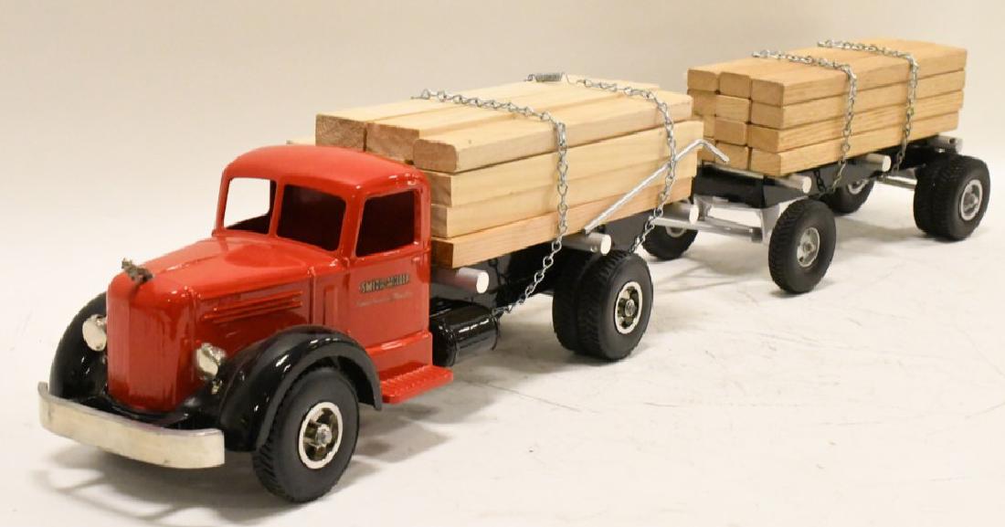 Restored Smith Miller L-Mack Lumber Truck w Pup: Nice restored Smith Miller L-Mack lumber truck with pup. Nice condition with light wear from display and storage. Measures approximately 36" long.
