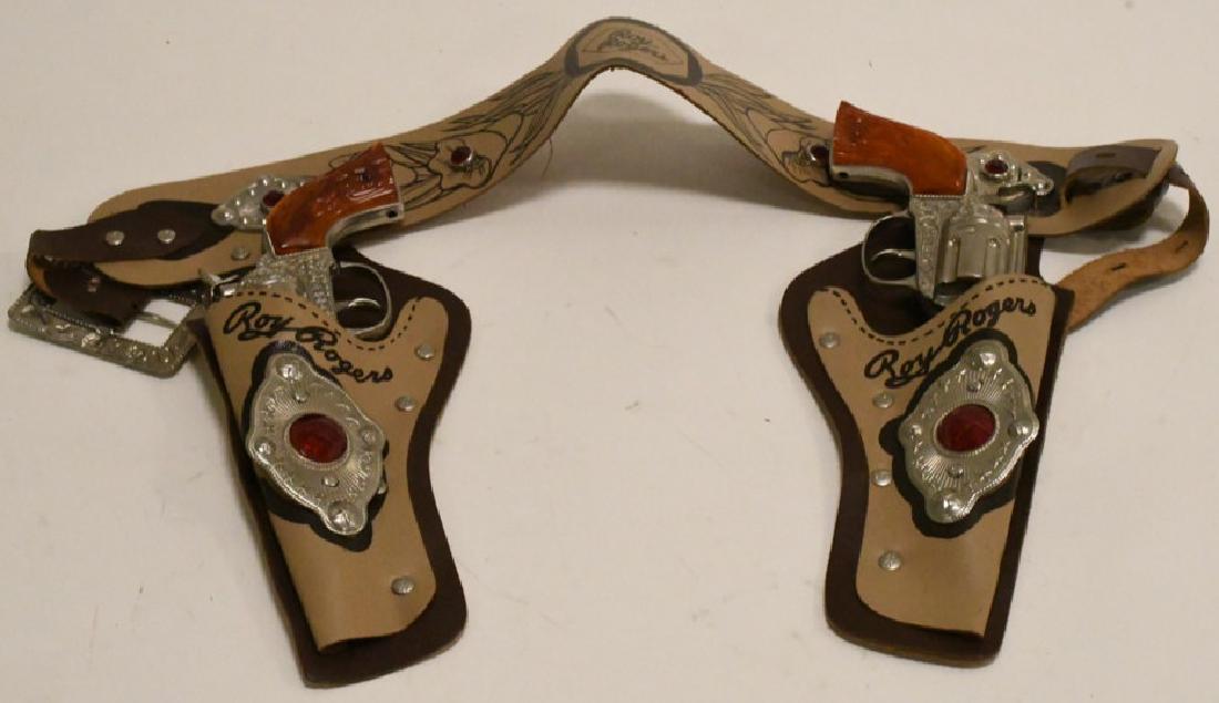 Hubley Roy Rogers Rodeo Cap Guns & Belt: Great condition vintage Hubley Roy Rogers Rodeo Cap Guns with belt. The guns work and the belt is nice. Guns measure 8.5" long.