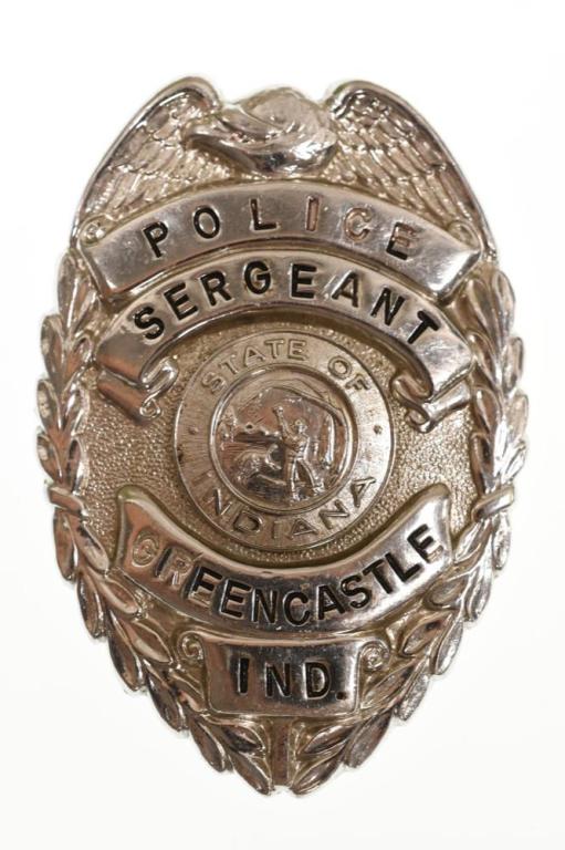 Obsolete Greencastle Indiana Police Sergeant Badge: Nice obsolete Greencastle Indiana Police Sergeant Badge. Badge is in good condition with a missing pinback. Back is unmarked. It measures approximately 3" tall by 2-1/8" across.