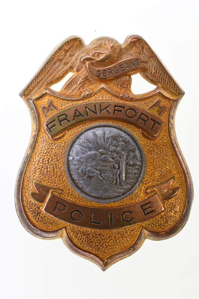 Obsolete Frankfort Indiana Police Sergeant Badge: Nice obsolete Frankfort Indiana Police Sergeant Badge. Badge is in nice condition with pinback. Back is unmarked. It measures approximately 3-1/8" tall by 2-1/4" across.