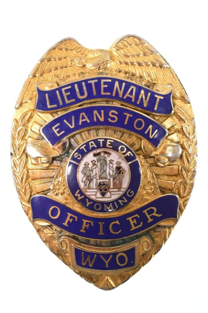 Obsolete Evanston Wyoming Police Lieutenant Badge: Nice obsolete Evanston Wyoming Police Officer Lieutenant Badge. Badge is in nice condition with pinback and enamel state seal. Back is unmarked. It measures approximately 3-1/8" tall by 2-1/4" across.