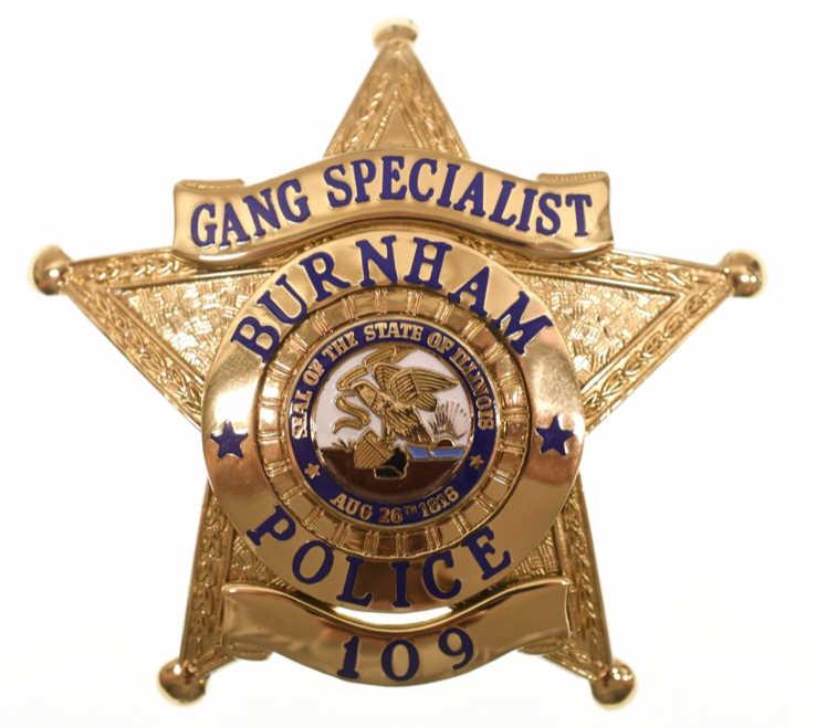 Obsolete Burnham ILL. Police Gang Specialist Badge: Nice obsolete dated 2002 five-point star Burnham Illinois Gang Specialist Badge #109. Badge is in nice condition with pinback. Back is maker marked Custom Insignia Phoenix Arizona. It measures approxi
