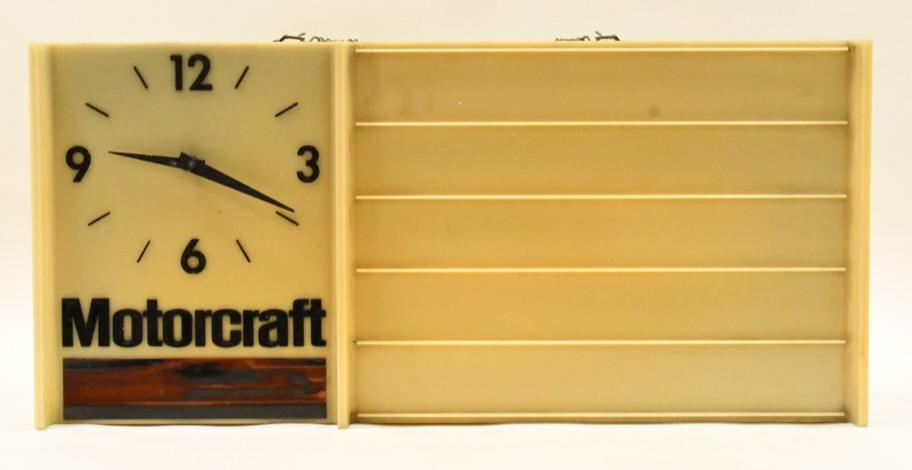 Vintage Motocraft Lighted Advertising Clock: Nice vintage Motocraft lighted advertising clock. Clock is in nice condition with discoloration and wear from use and age. Clock appears to run and it does light up. It measures approximately 28" acro