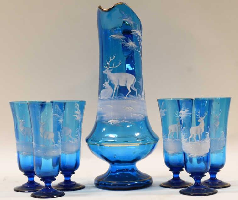 Antique Mary Gregory 7 Piece Painted Water Set: Nice antique Mary Gregory 7 piece painted blue glass water set with painted deer. The water pitcher measures 14" tall and the six glasses measure 6.75" tall. The set is in nice antique condition with 