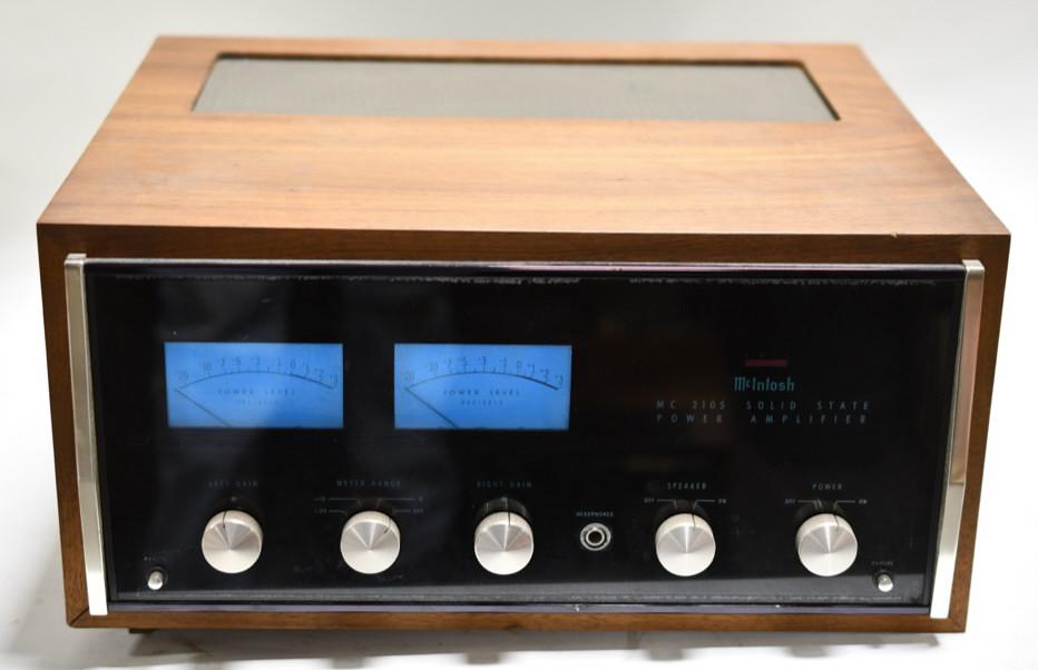 McIntosh Model MC2105 Stereo Power Amplifier: Wood cased unit lights up, though a bulb may be out. Back of the unit has some wear to the particle wood(see photos), and is untested by auction company other than to see if it lights up.