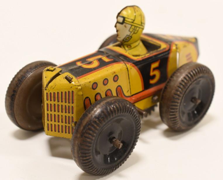 Marx Tin Litho Windup Boat Tail Racer #5: Nice Marx tin litho friction #5 Boat Tail Racer. Car has paint loss and wear from age. Displays well with original man. Wind up needs work. Measures approximately 5" long.