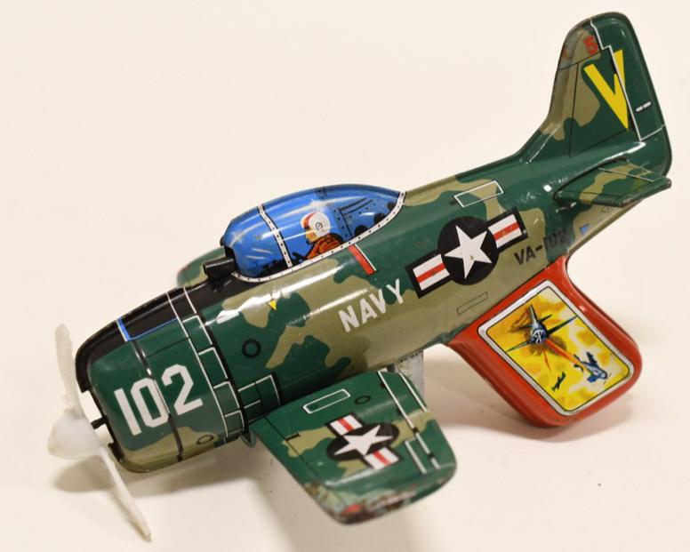 Nomura Tin Friction Trigger Powered Navy Plane: Nice Nomura tin friction trigger powered Navy VA-102 plane. Nice condition with light wear from age and play. The trigger is in working condition. Measures approximately 8" long.