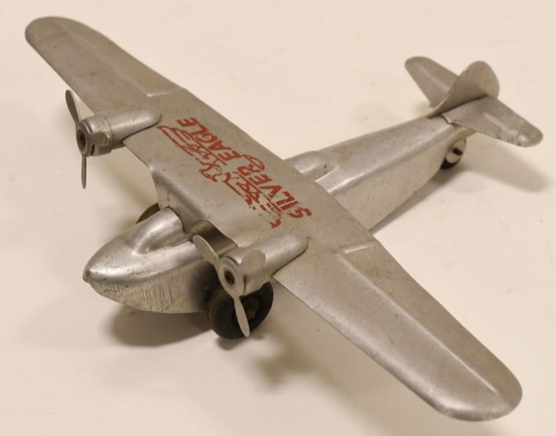 Aluminum Windup Silver Eagle Plane: Nice aluminum windup Silver Eagle plane. Displays nicely with light wear from age and play. Wingspan measures approximately 13" long.