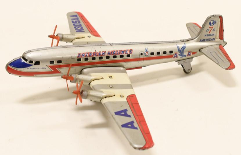 Marx Tin Friction American Airlines DC-7: Nice Marx tin friction American Airlines DC-7 Flagship Allison plane. Displays nicely with light wear from age and play. Wingspan measures approximately 15 1/2" long.