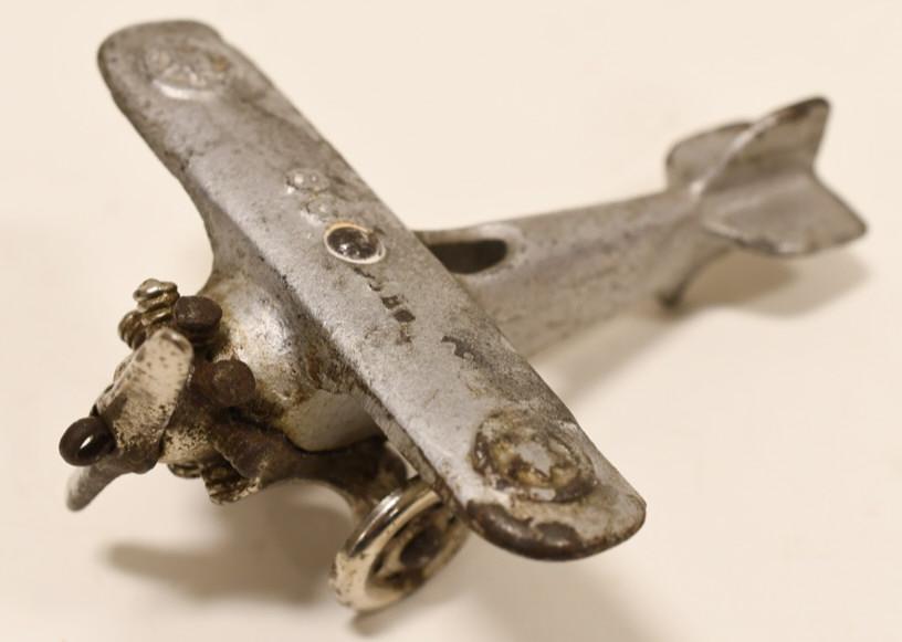 Hubley UX 99 Cast Iron Toy Plane: Nice Hubley UX 99 cast iron toy plane. Displays well featuring nickel plated wheels and propellor. UX 99 is embossed on the top of the wings. Wingspan measures approximately 4" long.
