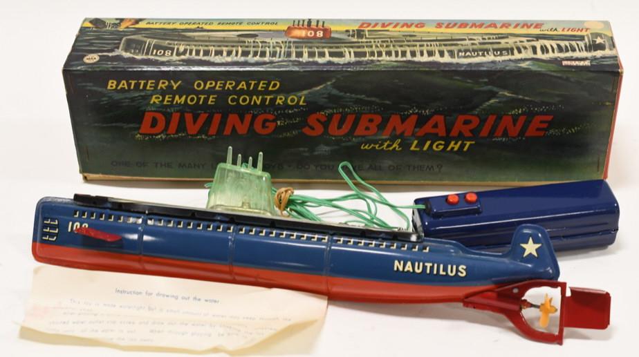 Linemar Battery Op Remote Control Diving Submarine: Nice Linemar tin battery operated remote control diving submarine. DIsplays nicely with light wear from play and age Comes with the original box and instructions. Toy is untested. Measures approximate