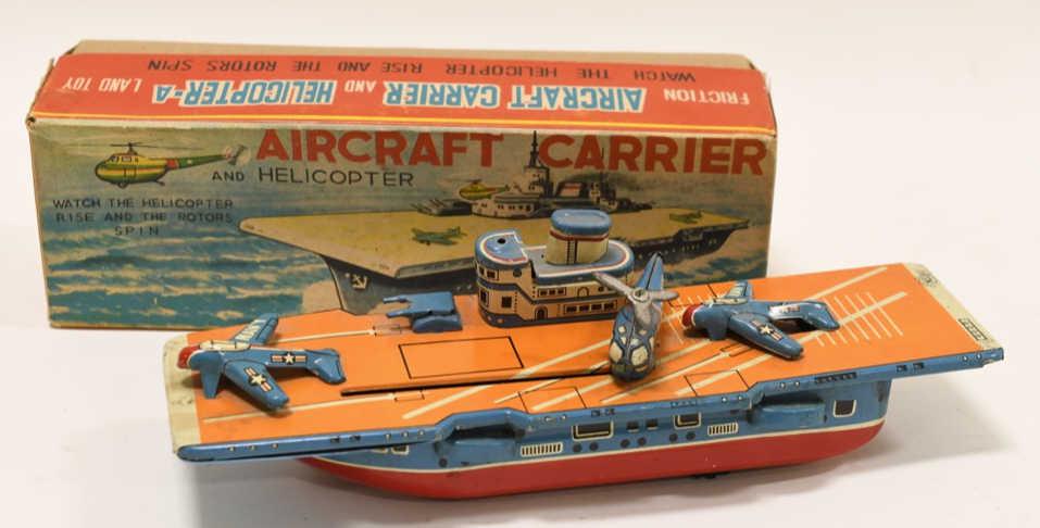 N.S. Tin Friction Aircraft Carrier and Helicopter: Nice N.S. Japan tin friction Aircraft Carrier and Helicopter. Displays nicely with light wear from play and age. Has a few scratches. Toy is in working condition. Comes with the original box. Measures